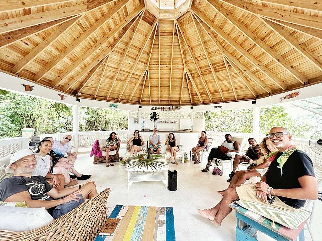 Group photo of participants sitting together at a psychedelic retreat in Negril, Jamaica.